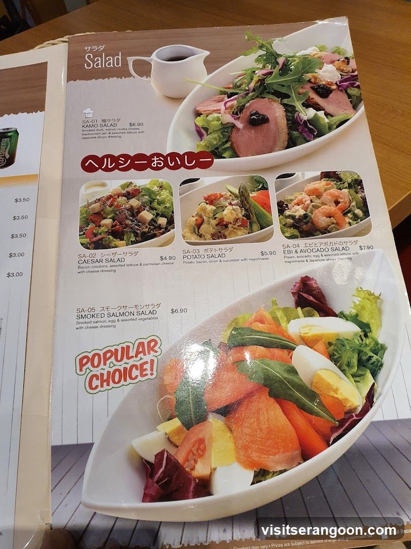 A printed menu page featuring various salad dishes with photos and prices.