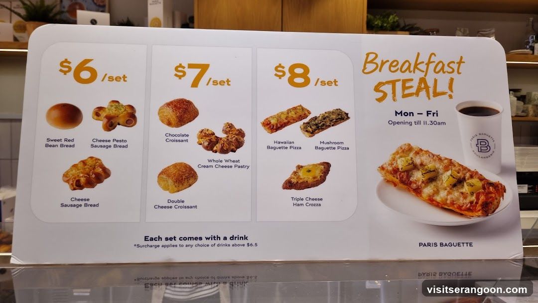A printed menu board advertising breakfast sets with prices of $6, $7, and $8, featuring various breads, pastries, and pizzas, along with a drink.