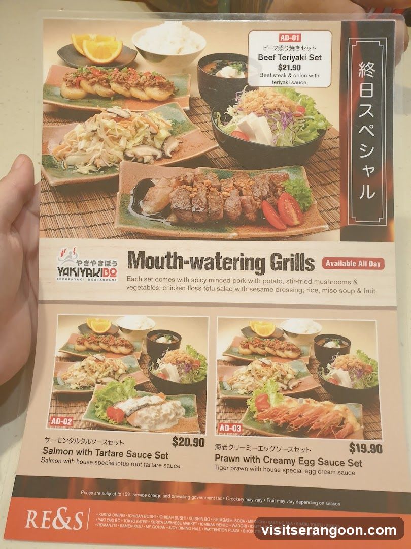 A printed menu page for Yakiyaki Do featuring 'Mouth-watering Grills' available all day. The page displays three specific set meals with photos and descriptions.