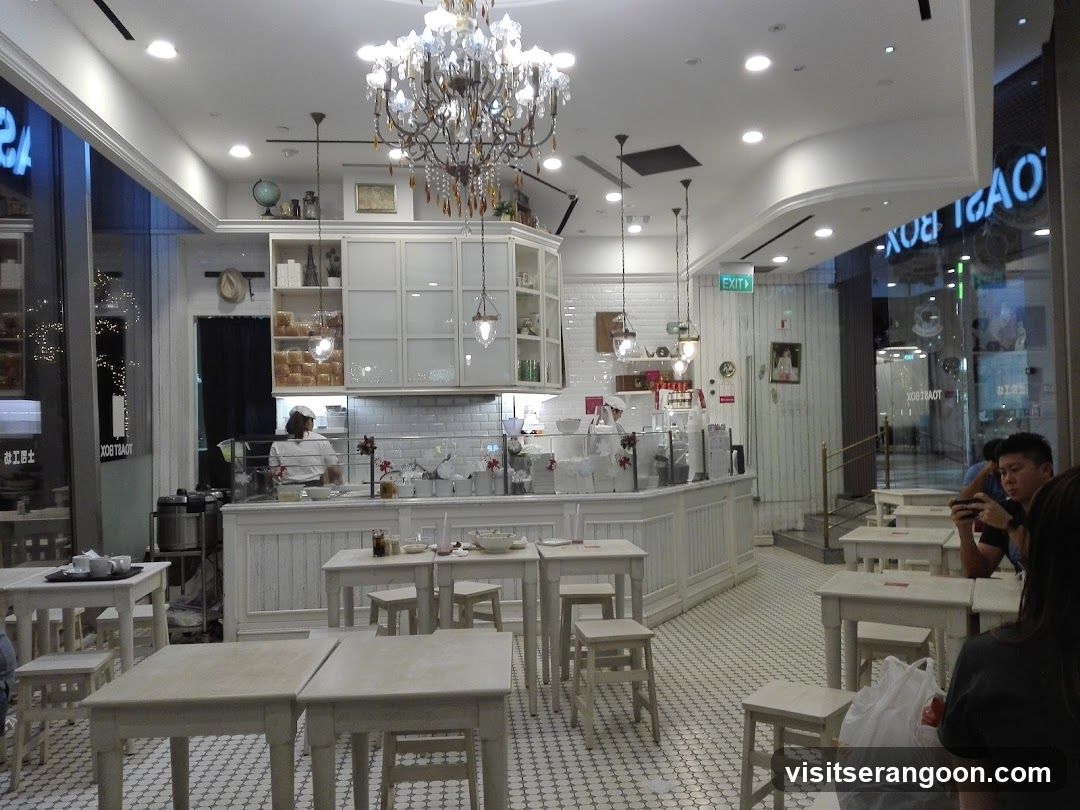 Interior of a cafe with white tables and chairs