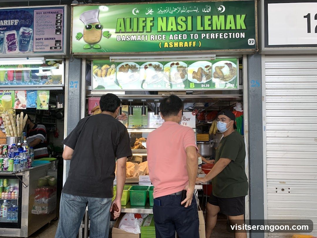 A food stall with a green awning and a cartoon potato mascot. The stall's name,