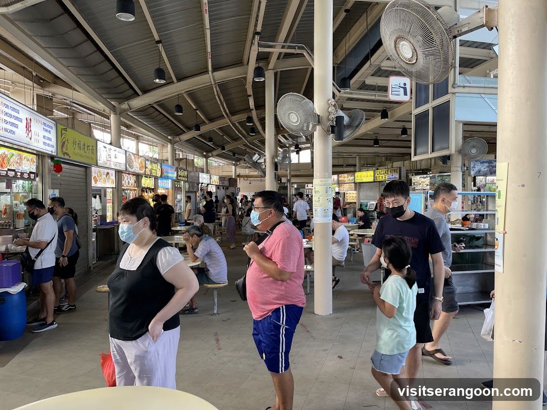 Food court with people dining and queuing