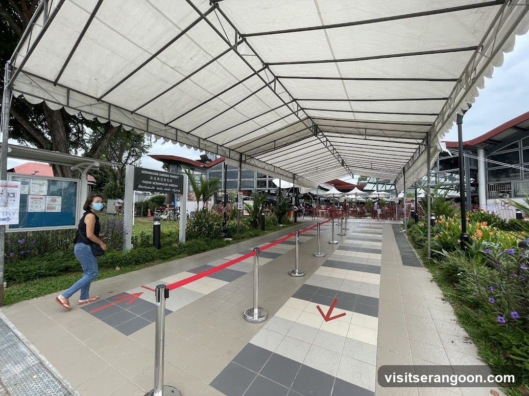Covered walkway with directional arrows and signage