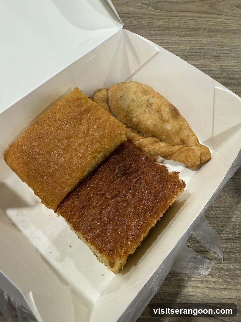 Two slices of cake and an empanada in a takeout box