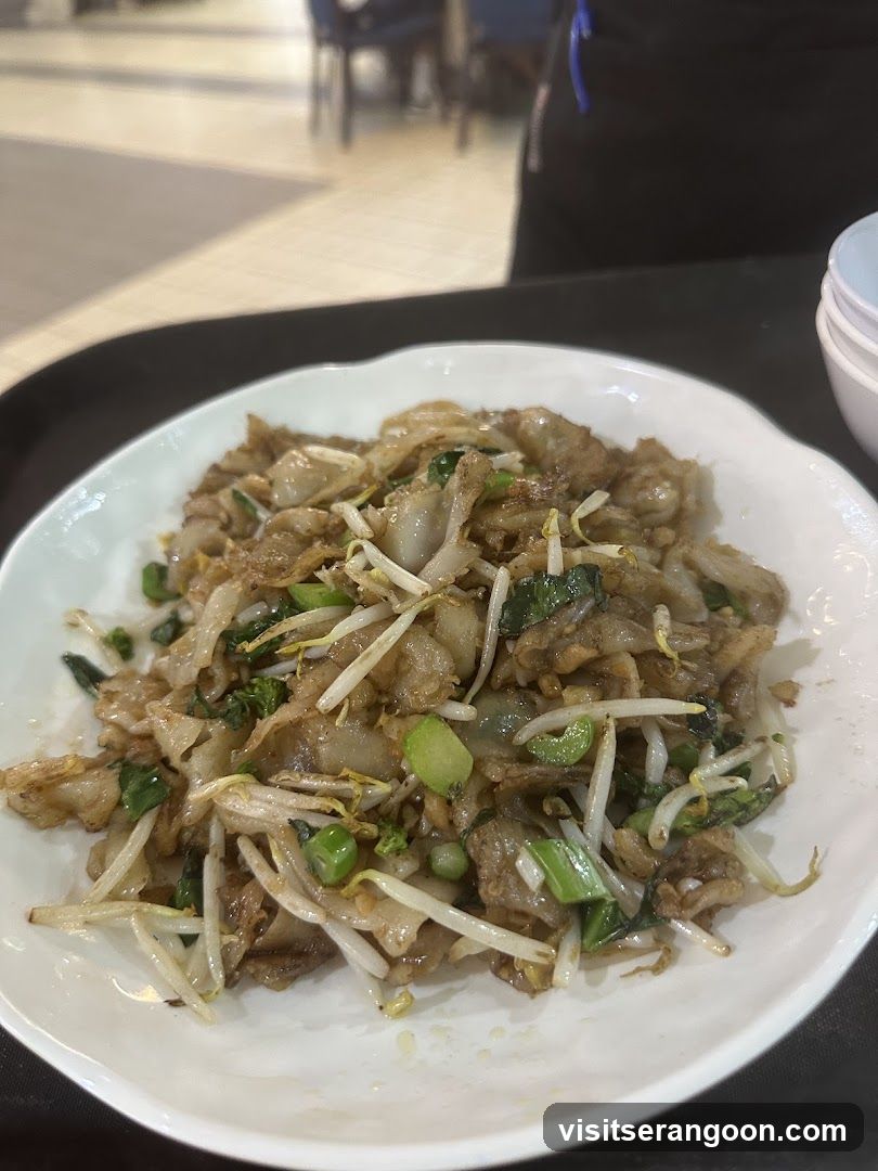 Stir-fried noodles with bean sprouts and greens