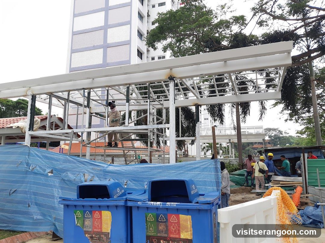 Construction Site with Workers and Recycling Bins