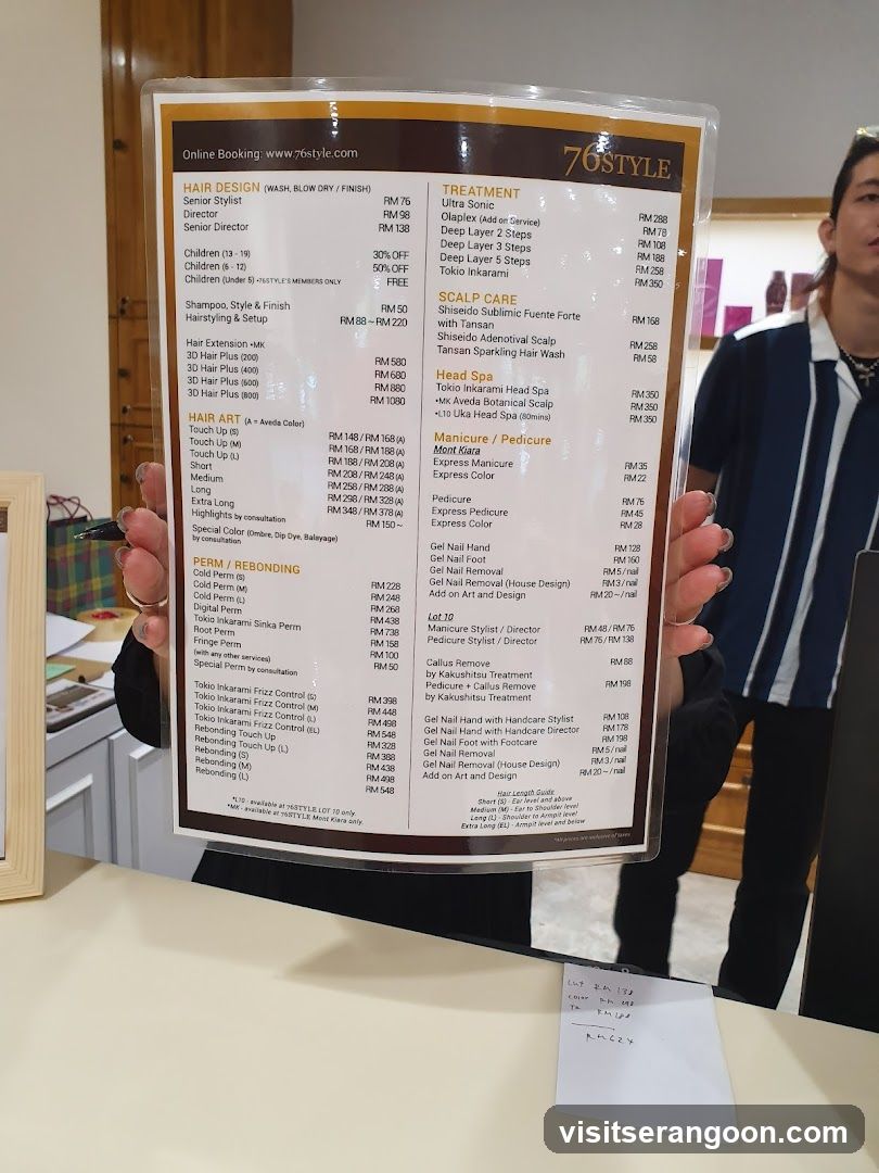 A laminated menu is held up, displaying various hair and nail services with prices.