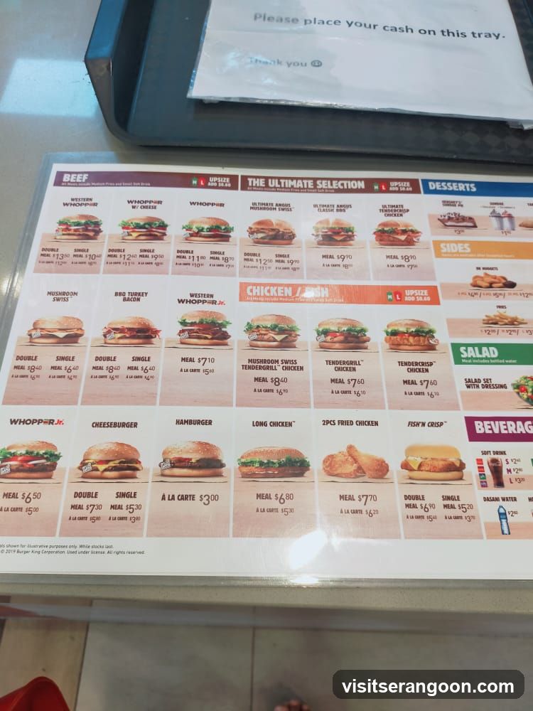 A menu board displaying various burgers, chicken items, sides, desserts, salads, and beverages.