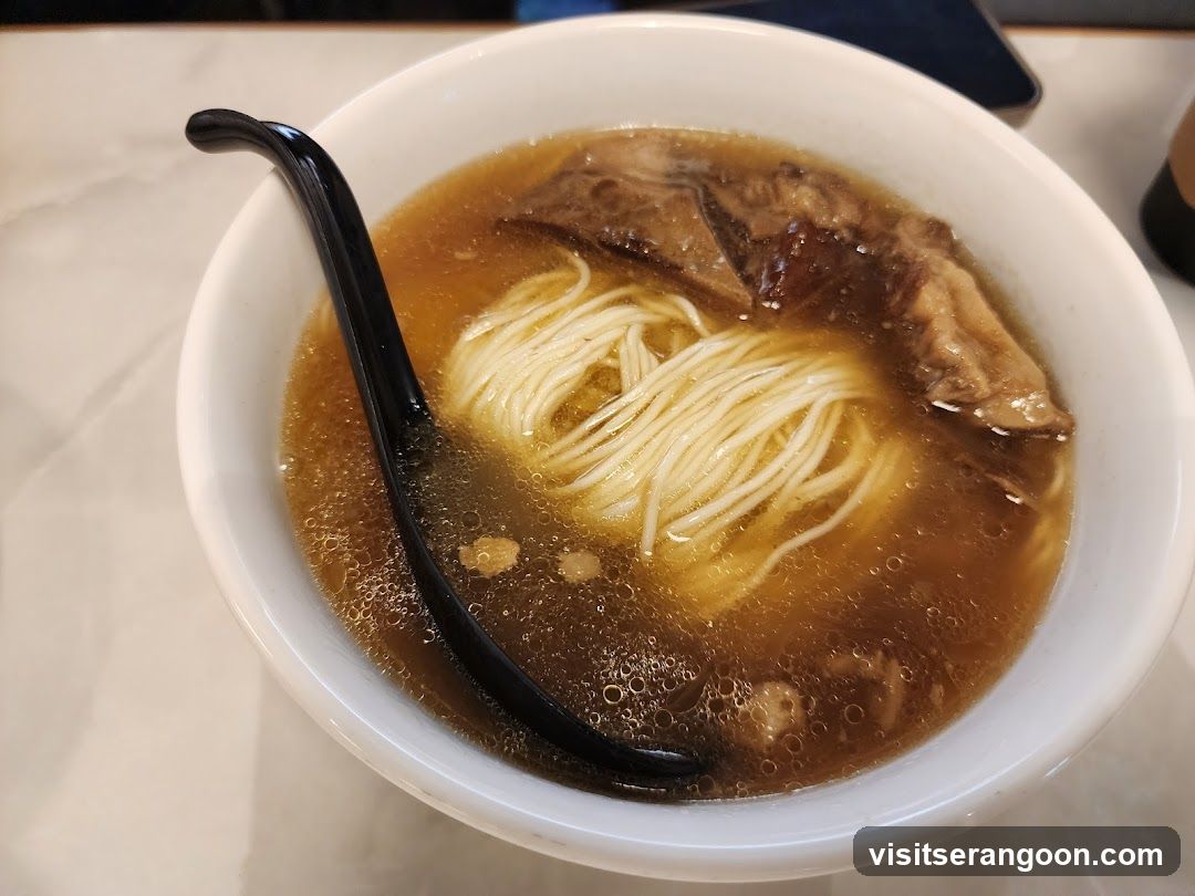 Bowl of Noodle Soup with Black Chopsticks