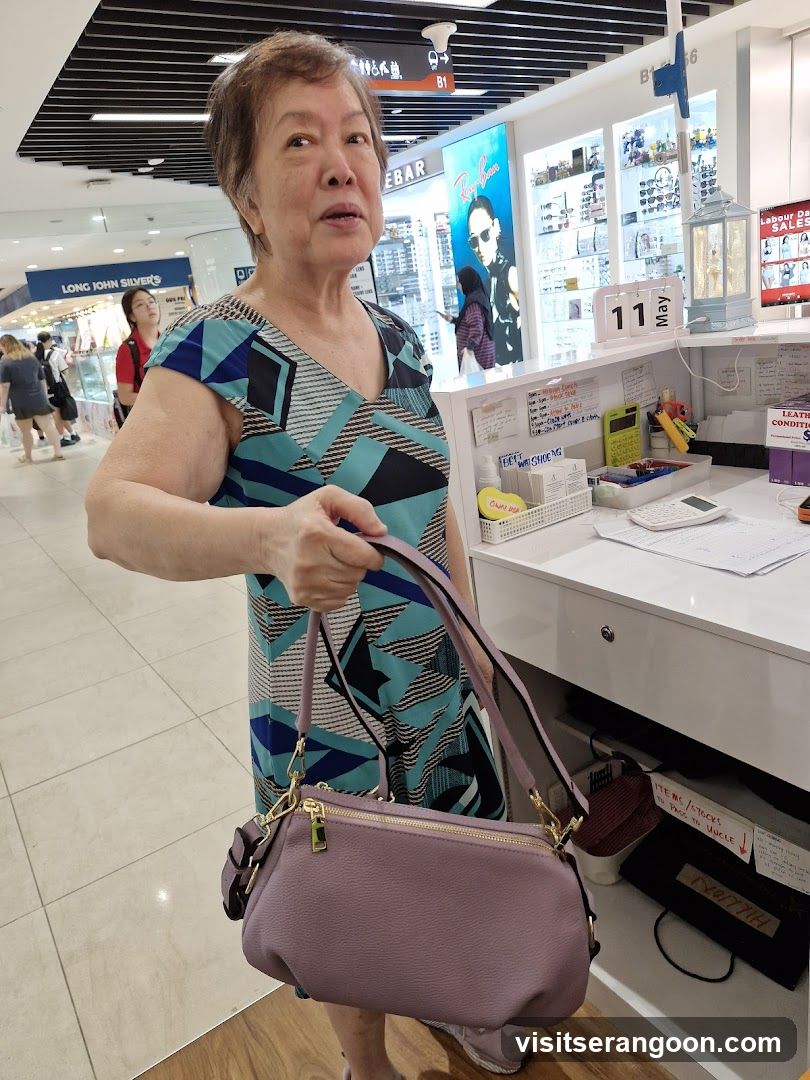 Woman holding a purple handbag in a mall