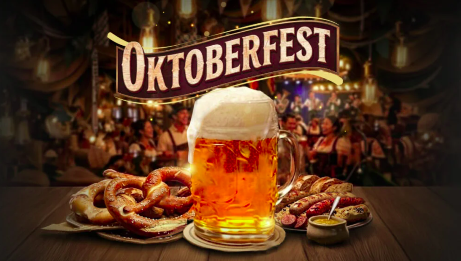 Long Oktoberfest banquet tables with pretzels, beer mugs, and diners in a decorated hall